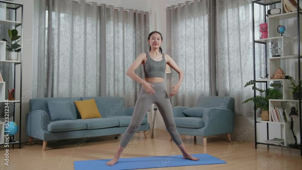 Full View Of Young Asian Trainer Female In Sports Clothes Speaking And Stretching While Teaching Exercise At Home
Full View Of Young Asian Trainer Female In Sports Clothes Speaking And Stretching While Teaching Exercise At Home
