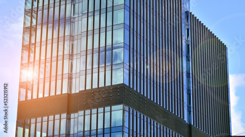 Wallpaper Mural  Modern glass facade against blue sky. Bottom view of a  building in the business district. Low angle view of the glass facade of an office building. Torontodigital.ca