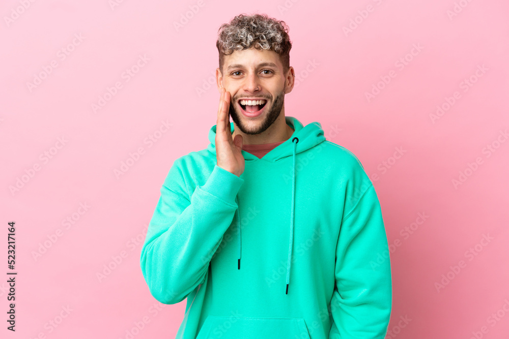 Young handsome caucasian man isolated on pink background with surprise and shocked facial expression Young handsome caucasian man isolated on pink background with surprise and shocked facial expression