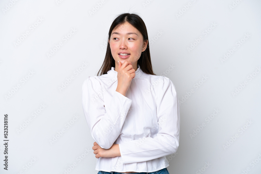 Young Chinese woman isolated on white background looking to the side and smiling Young Chinese woman isolated on white background looking to the side and smiling