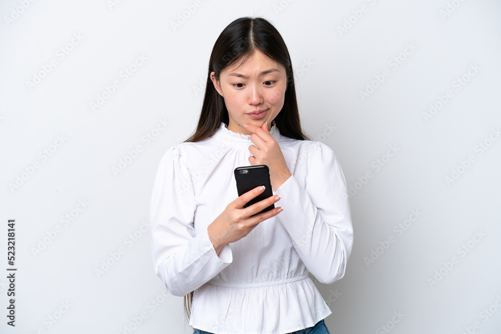 Young Chinese woman isolated on white background thinking and sending a message Young Chinese woman isolated on white background thinking and sending a message