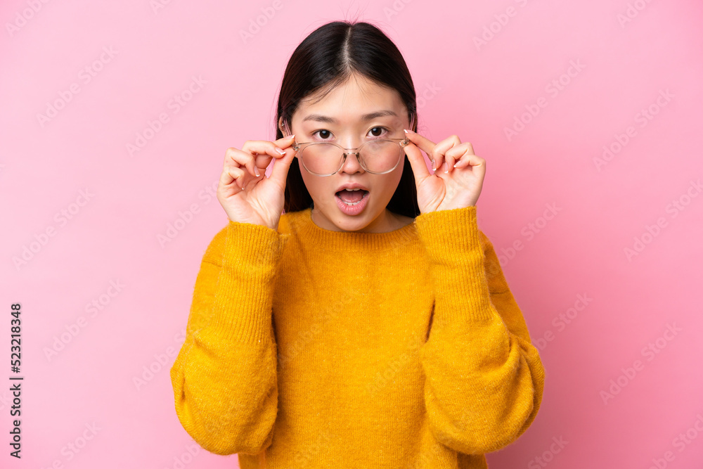 Young Chinese woman isolated on pink background With glasses and surprised expression Young Chinese woman isolated on pink background With glasses and surprised expression