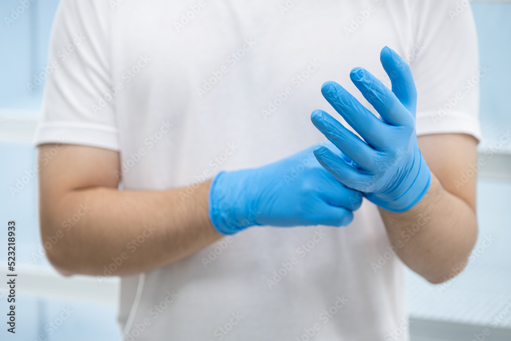 Doctor wearing blue nitrile gloves (select focus) Doctor wearing blue nitrile gloves (select focus)