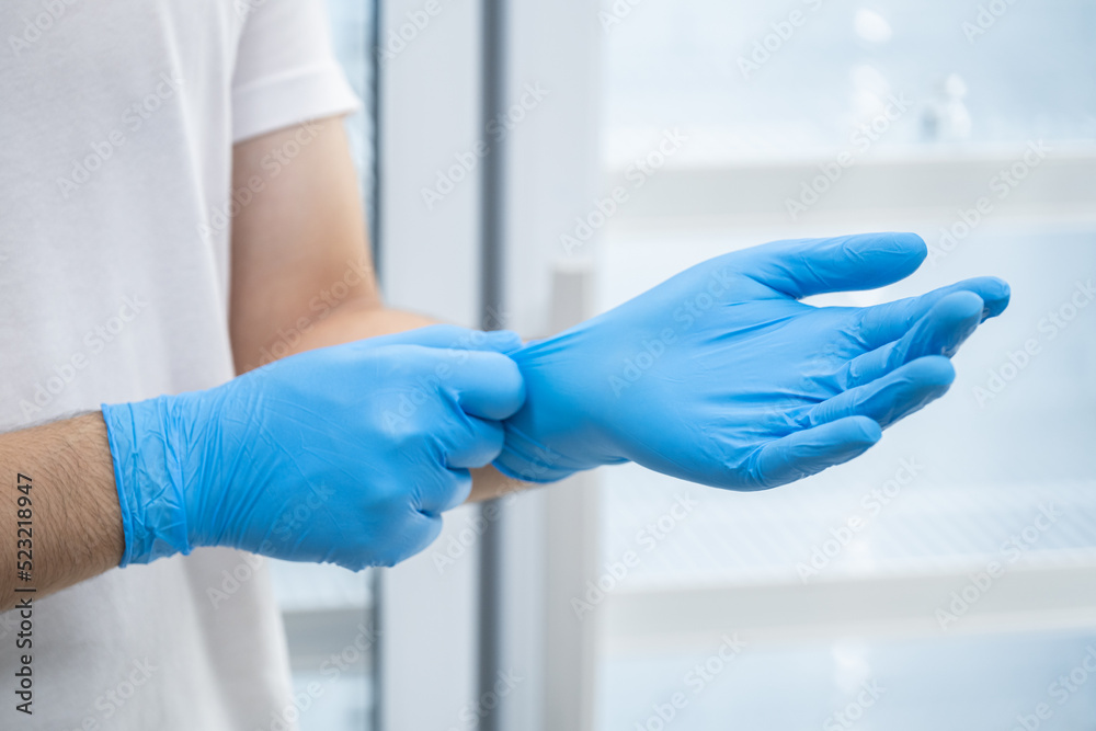 Doctor wearing blue nitrile gloves (select focus) Doctor wearing blue nitrile gloves (select focus)