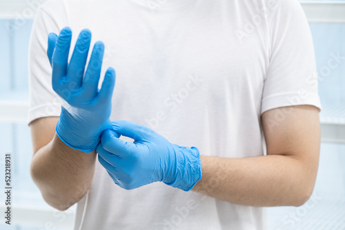 Doctor wearing blue nitrile gloves (select focus)