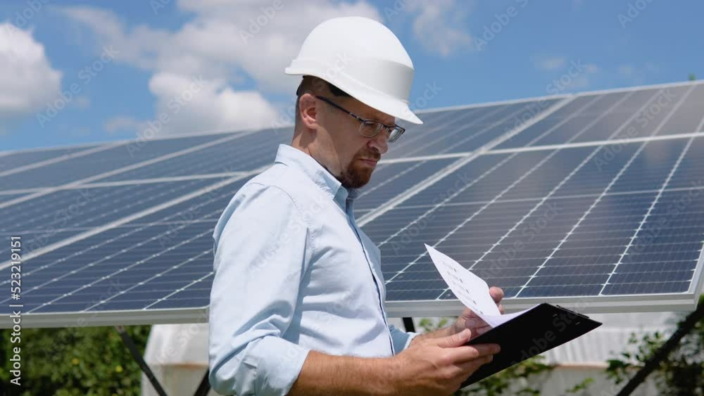Engineers checking solar panels with tablet. Alternative energy ecological concept Engineers checking solar panels with tablet. Alternative energy ecological concept