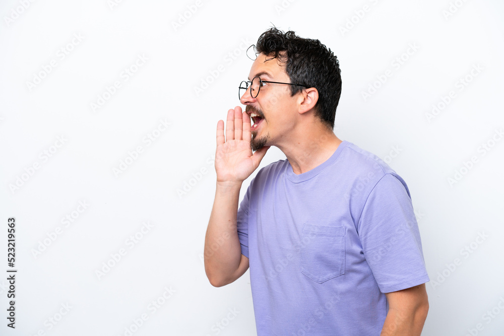 Young man with moustache isolated on white background shouting with mouth wide open to the side Young man with moustache isolated on white background shouting with mouth wide open to the side