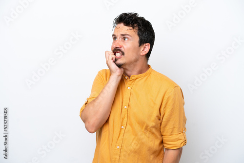 Young man with moustache isolated on white background is a little bit nervous