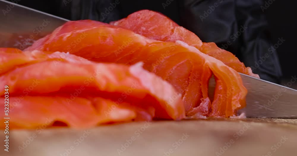 cut red salted fish into chunks while cooking, cooking sandwiches using red salmon fish cut red salted fish into chunks while cooking, cooking sandwiches using red salmon fish