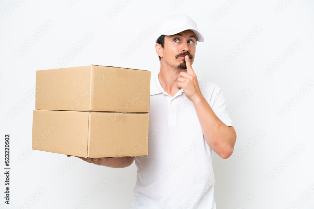 Delivery caucasian man isolated on white background having doubts while looking up Delivery caucasian man isolated on white background having doubts while looking up
