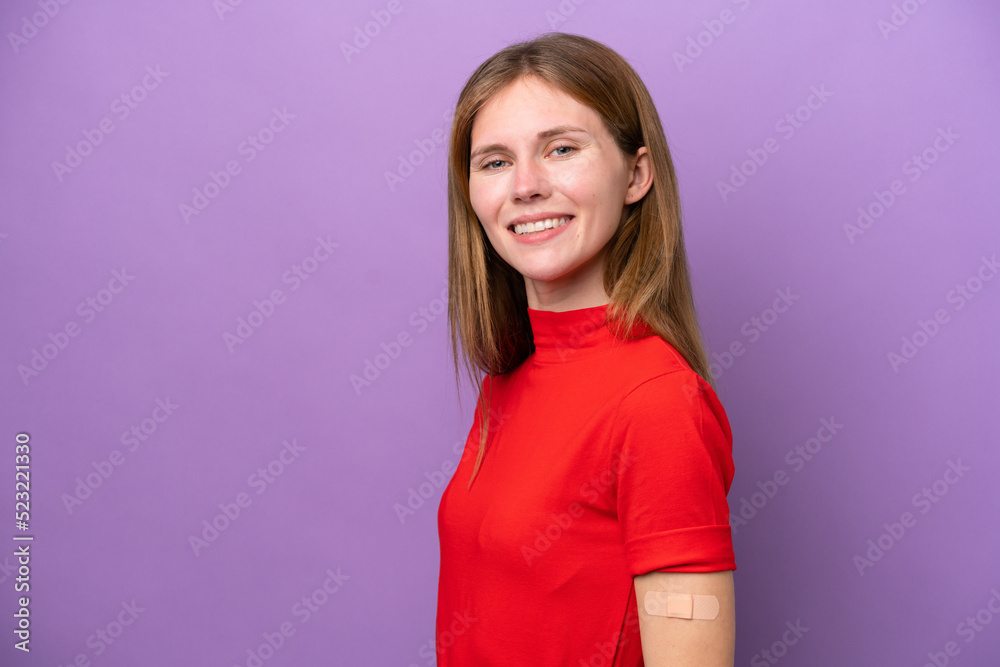 Young English woman wearing band-aids isolated on purple background smiling a lot Young English woman wearing band-aids isolated on purple background smiling a lot