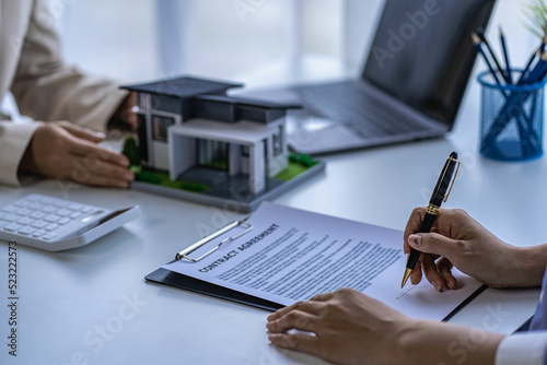 Home agents talk to new home buyers and offer good interest rates and calculate clients on mortgage financing to help make real estate concept decisions. 