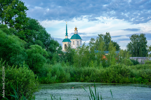 Photography duckweed covered lake kiovo, moscow region, russia, Orthodox church on the shore