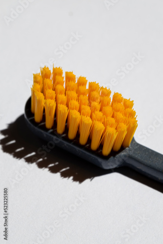 orange Toothbrush head close-up view, isolated on white background, macro