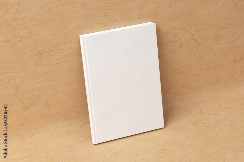 Blank vertical hardcover book cover mockup standing on wooden background Blank vertical hardcover book cover mockup standing on wooden background