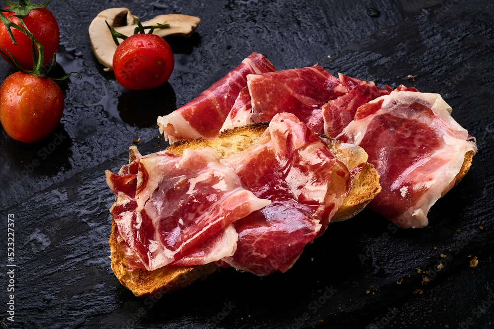 Iberian ham slices on a slice of toasted bread
