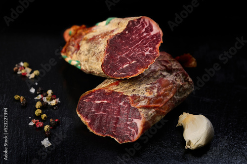 Iberian loin on black slate with peppercorns and garlic