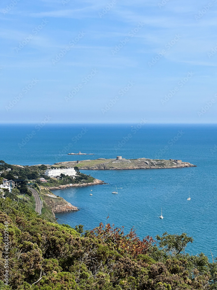 View of Dalkey Island from Killiney Hill with sailboats parked up on a sunny day in Ireland