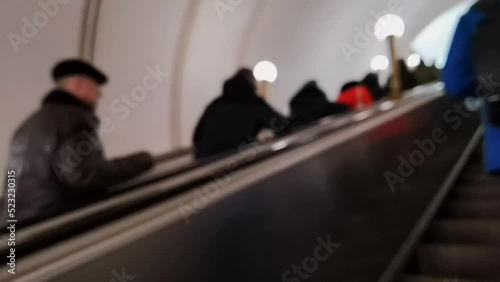 Unrecognised people in underground. Metro station inside. Person go to work or holiday. Winter clothes. Empty subway