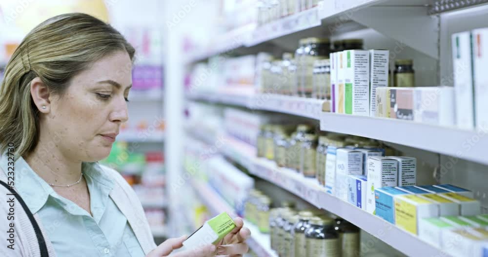 Young woman at a drug store, browsing shelves and looking for medicine, treatment or vitamins. A customer searching for medical relief, preparing for seasonal flu or immune system boosters
