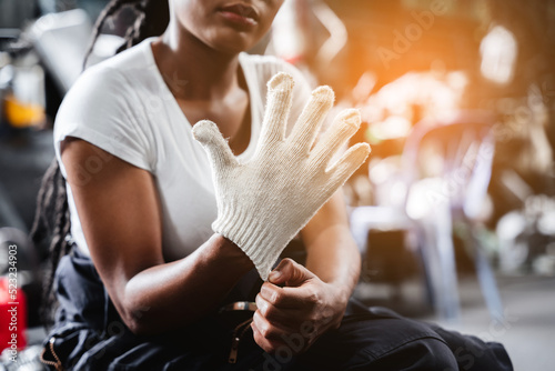 Close up hand mechanics wear gloves to prevent danger. in the garage