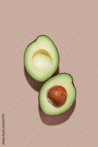 cut avocado on beige background