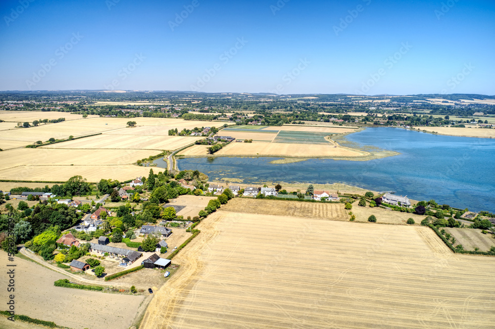 Obraz premium Aerial view of the small Parish of Chidham surrounded by the beautiful countryside of West Sussex in Southern England and the Bosham estuay.