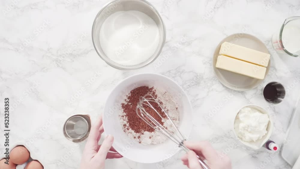 Time lapse. Step by step. Mixing wet ingredients in a glass mixing bowl to bake red velvet cupcakes. Time lapse. Step by step. Mixing wet ingredients in a glass mixing bowl to bake red velvet cupcakes.