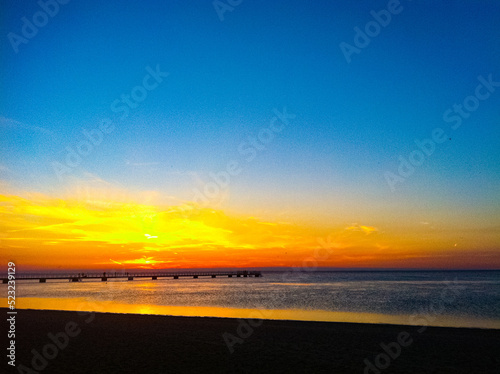 Sunset over Oresund sea seen from Ribban beach in Malmo, Sweden photo