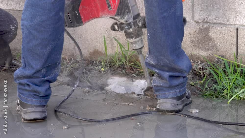 Workers Fixing A Water Leak And Using A Jack Hammer To Break The Cement Workers Fixing A Water Leak And Using A Jack Hammer To Break The Cement