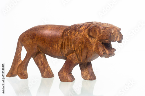 Wooden lion figurine on a white background. Home decoration. Close up