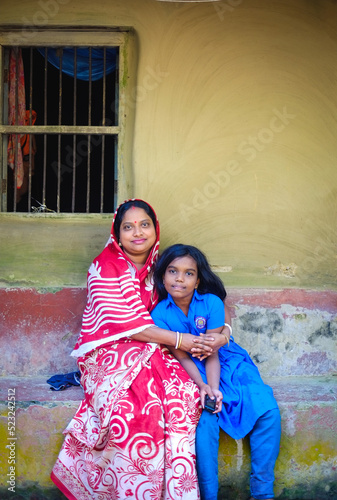 Portrait of south asian hindu religious woman with her daughter, Bangladeshi village people in traditional dress  © Susmit