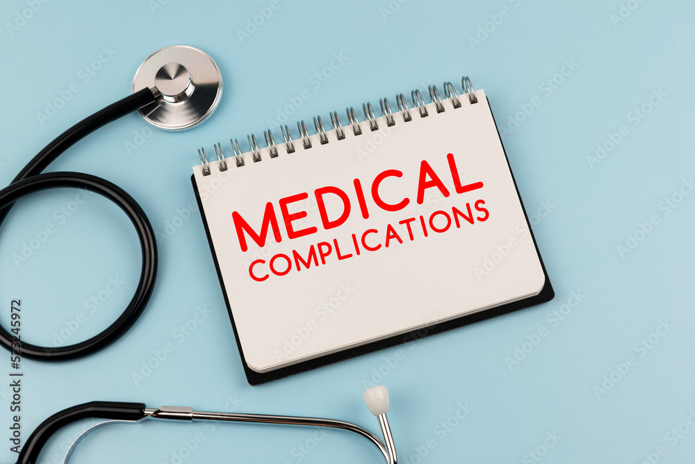 Medical complications text on note pad and stethoscope - obrazy, fototapety, plakaty 