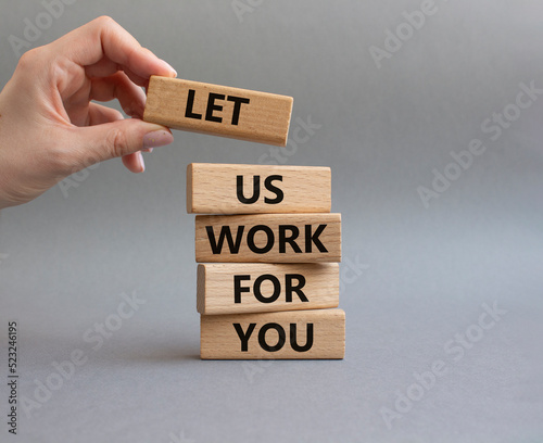 Let us work for you symbol. Wooden blocks with words Let us work for you. Beautiful grey background. Businessman hand. Business and Let us work for you concept. Copy space.