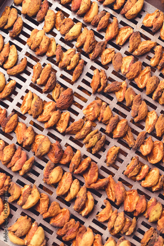 The process of home cooking dried fruits in an electric dryer.