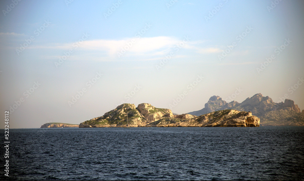 View on the jagged islands, in the distance, over the sea, against the clear sky, Parc National des Calanques, Marseille, France