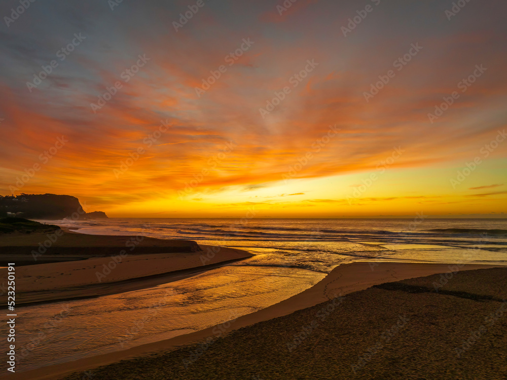 Sunrise and high cloud cover by the sea and lagoon Sunrise and high cloud cover by the sea and lagoon