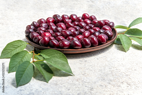 Ripe sweet cherries on plate. Bing Cherries. Dessert berries on ceramic dish. Mediterranean style