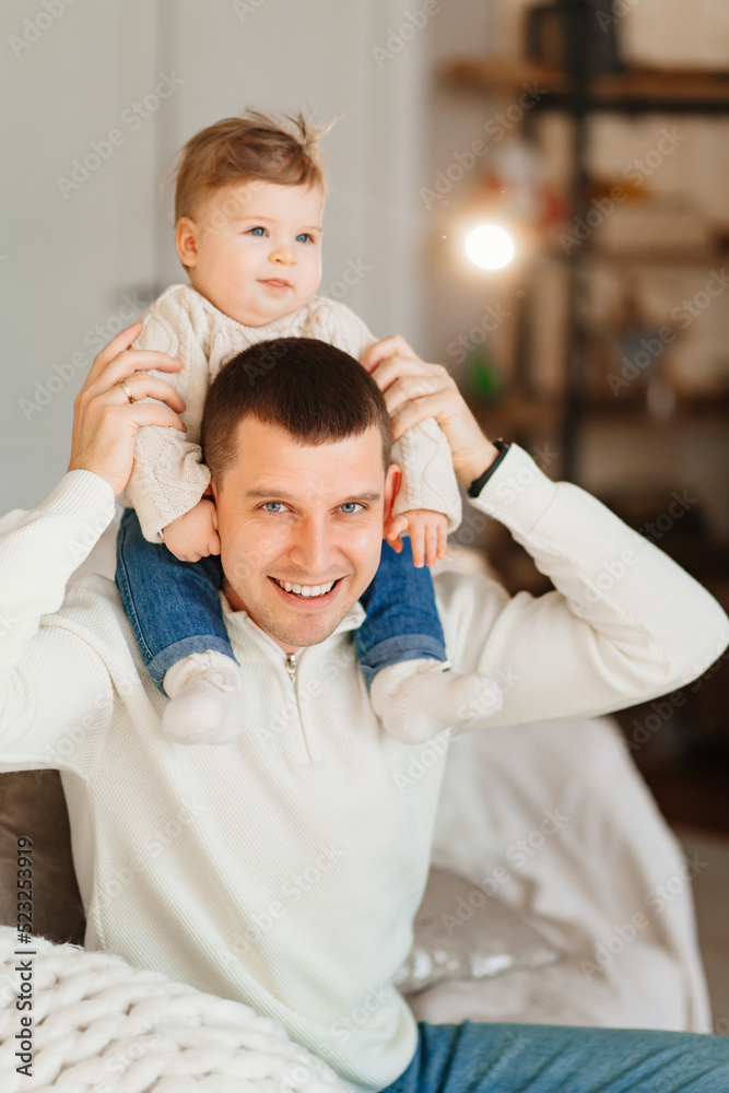 Dad riding his young son on shoulders. 