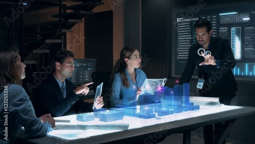 In the Near Future: Businessman presenting concept of 5G Wireless Network Connection to Colleagues and Partners sitting around Futuristic Table with Holographic Modern Augmented Reality Technology.