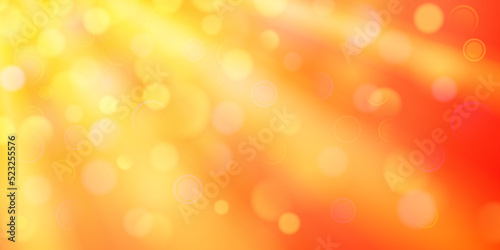 Abstract background in orange colors with diverging rays of light and small translucent circles with bokeh effect