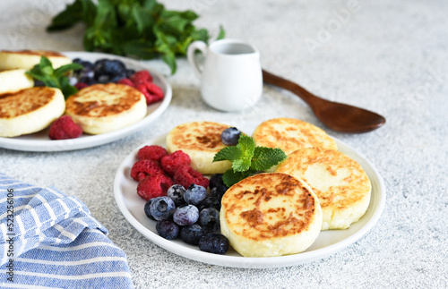 Cheesecakes with berries and sauce for breakfast.