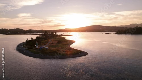 Aerial hyperlapse of ocean sunset, peninsula, boats in harbour, peaceful ocean sunset, Whiffen Spit, Sooke, Vancouver Island. 4K 24FPS photo
