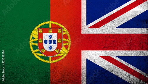 National flag of United Kingdom (Great Britain) Union Jack with Portugal National flag. Grunge background