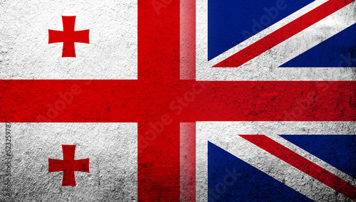 National flag of United Kingdom (Great Britain) Union Jack with The national five star flag of the country of Georgia. Grunge background