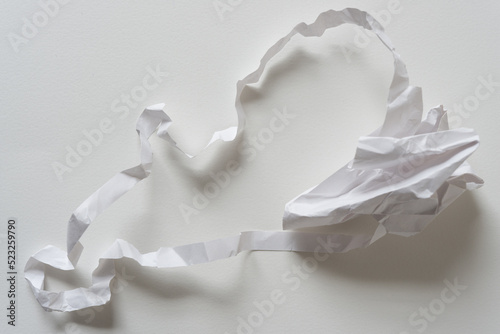 crumpled white paper  milk splash isolated on white 