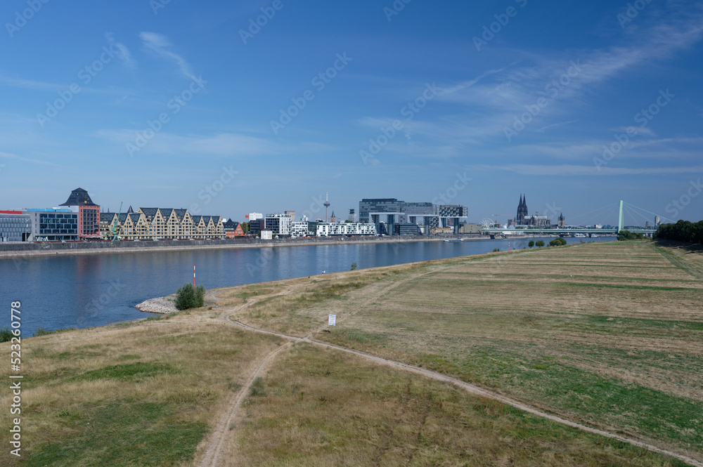 Cologne, Germany, August 10, 2022: rhine panorama from the stapelhaeuser over the kranhaeuser to the cologne cathedral during the drought period in summer 2022