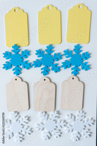 foam snowflakes and wooden tags on blank paper photo