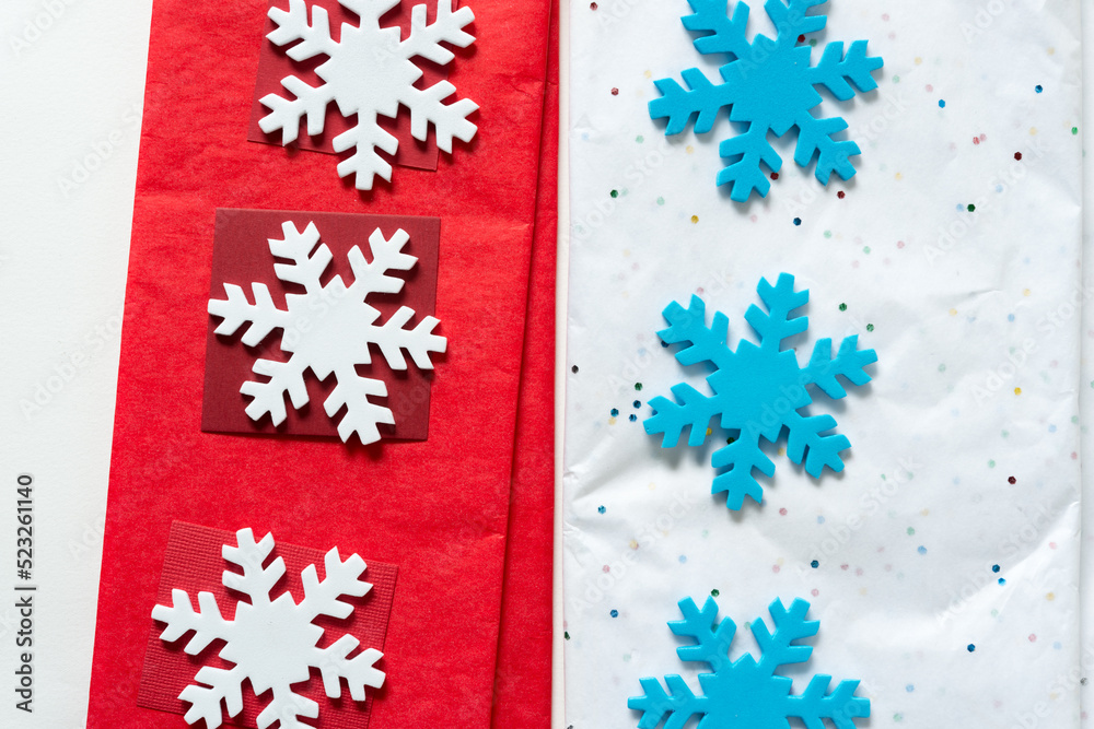 white and blue foam snowflakes on red and white tissue paper