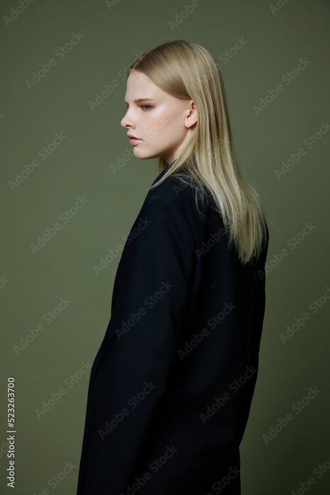 A beautiful attractive model poses with her back to the camera. Concept photo for clothing brands. Cool offer for fashionable suits A beautiful attractive model poses with her back to the camera. Concept photo for clothing brands. Cool offer for fashionable suits